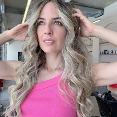 woman touching her blonding hair and highlights work